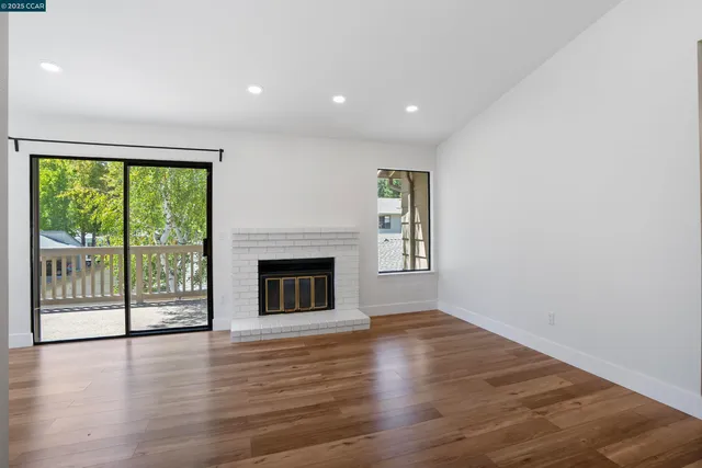 wooden floor in an empty room with a fireplace