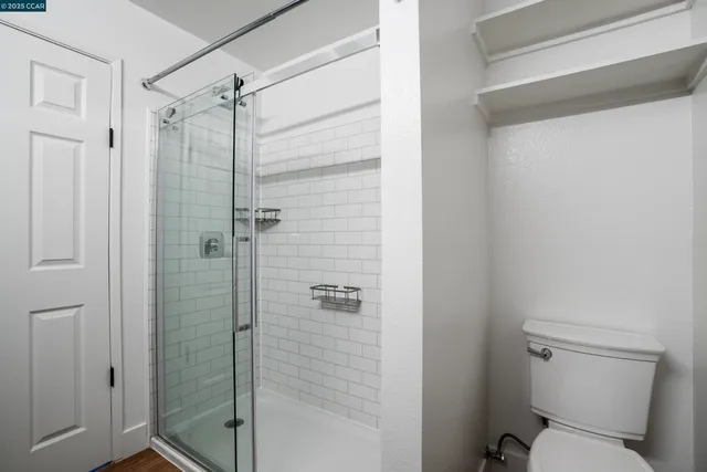 a bathroom with a toilet and shower