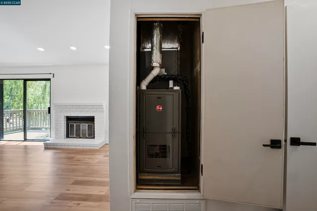 a view of a livingroom with wooden floor and a fireplace