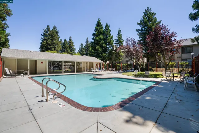 a view of a house with swimming pool and sitting area