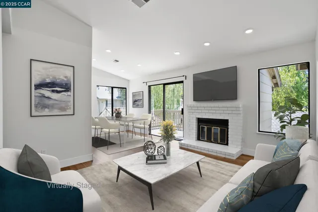 a living room with furniture a fireplace and a flat screen tv