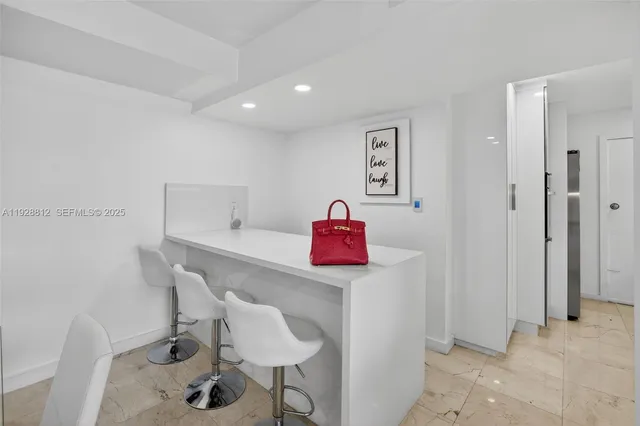 a metallic refrigerator freezer sitting in a kitchen
