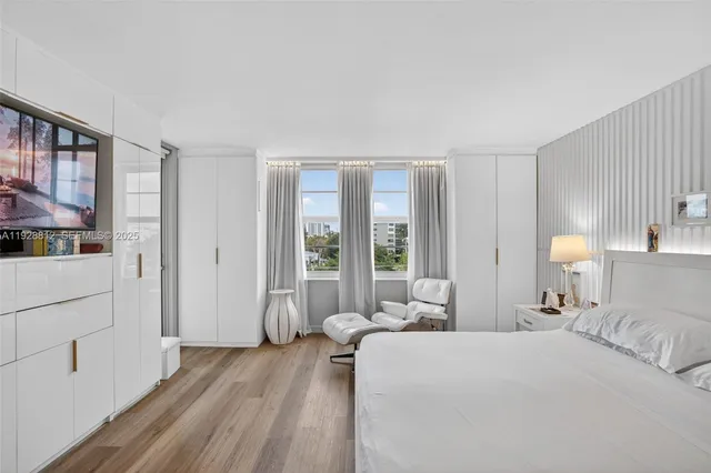 a view of a hallway with wooden floor and dining room with wooden floor