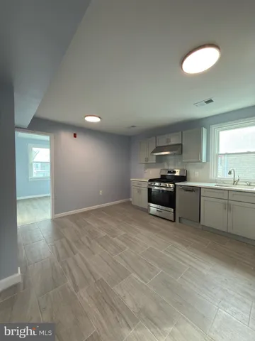 a view of a kitchen with a sink and a stove top oven