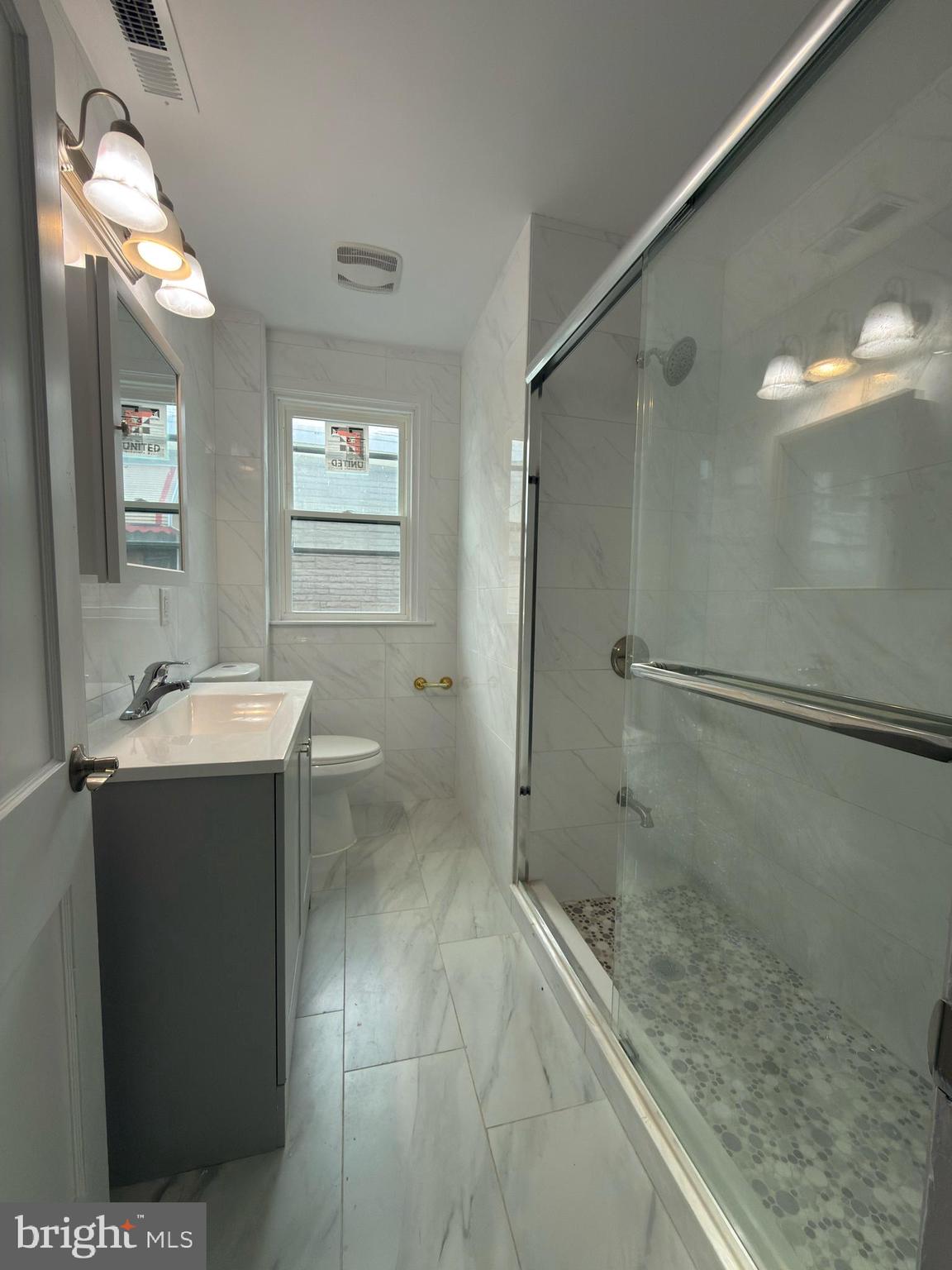 5734 Rising Sun Avenue Philadelphia, PA 19120 - Photo 6 of 8 a bathroom with a sink toilet and shower