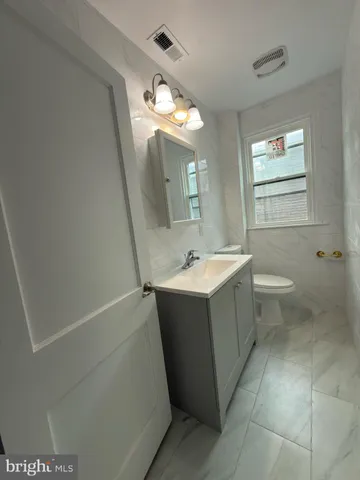 a bathroom with a sink vanity and mirror