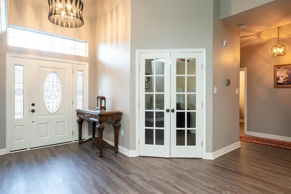 a view of a hallway with wooden floor windows and entryway