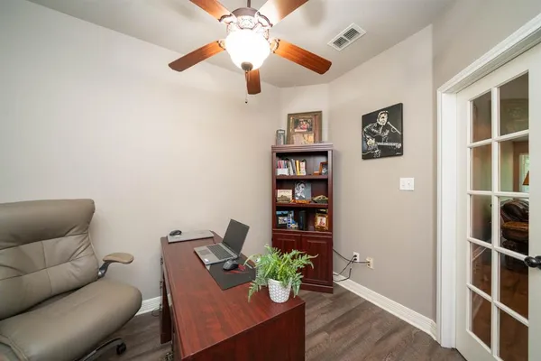 a living room with furniture and wooden floor