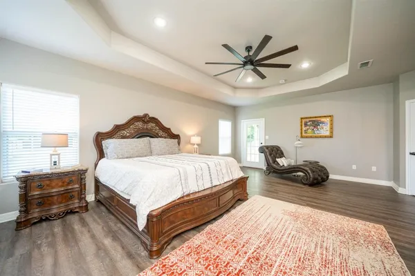 a bedroom with a bed and ceiling fan