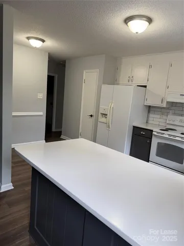 a kitchen with stainless steel appliances a refrigerator sink and cabinets