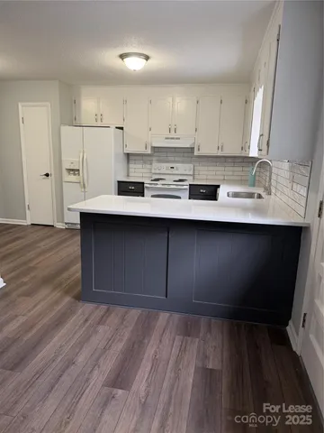 a kitchen with stainless steel appliances a sink stove and cabinets