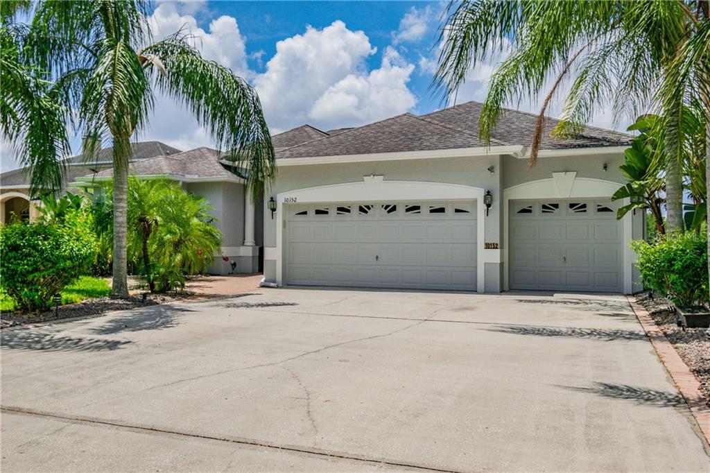 10152 Shooting Star Court New Port Richey, FL 34655 - Photo 1 of 1 a front view of a building with palm trees