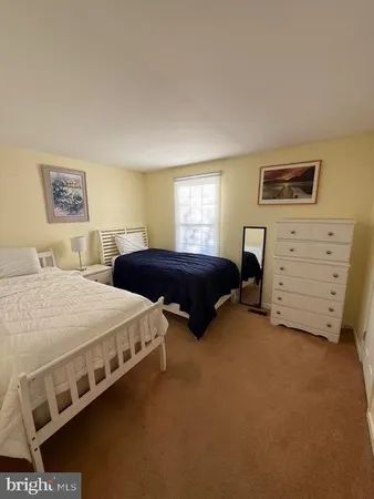 a spacious bedroom with a bed and a couch