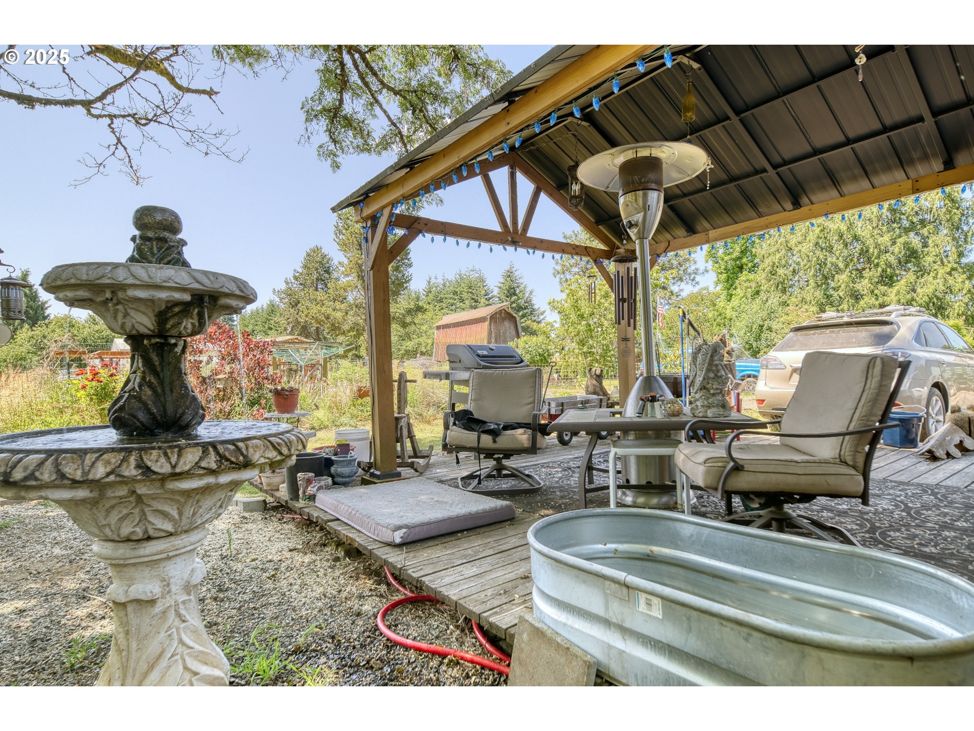 33812 Berg Road Warren, OR 97053 - Photo 14 of 20 a view of patio with table and chairs under an umbrella