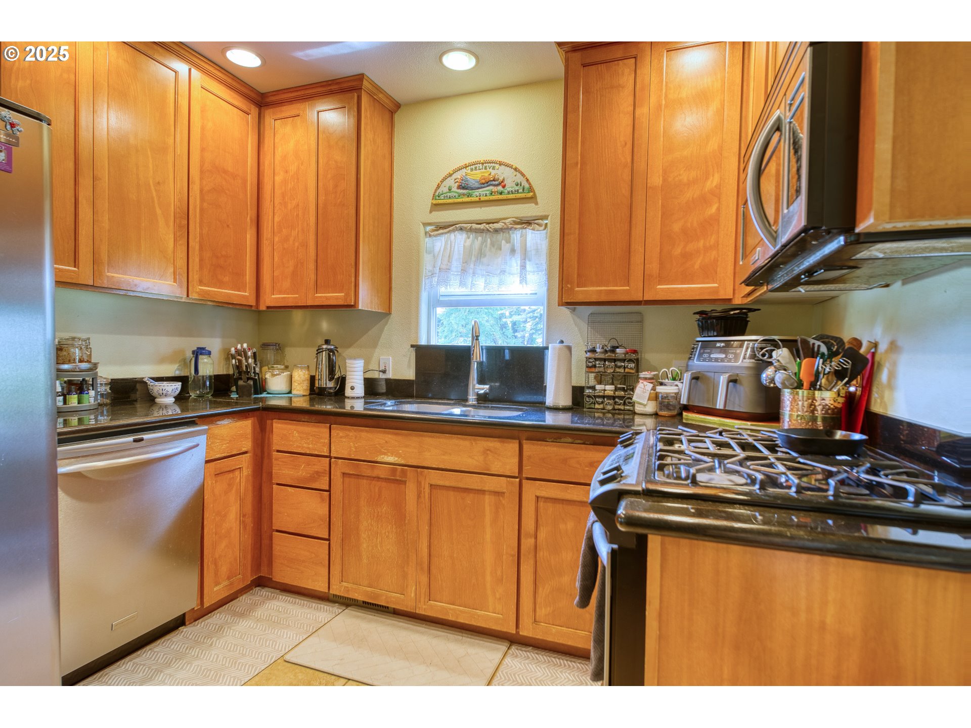 33812 Berg Road Warren, OR 97053 - Photo 8 of 20 a kitchen with stainless steel appliances granite countertop a stove a sink dishwasher and cabinets with wooden floor