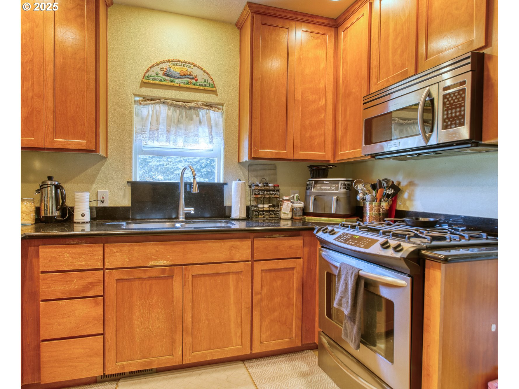 33812 Berg Road Warren, OR 97053 - Photo 9 of 20 a kitchen with stainless steel appliances granite countertop a stove and a microwave