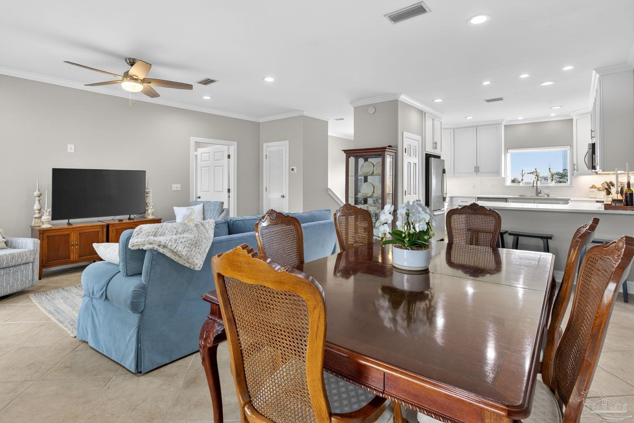 26355 Marina Road Orange Beach, AL 36561 - Photo 12 of 58 a living room with furniture and a flat screen tv