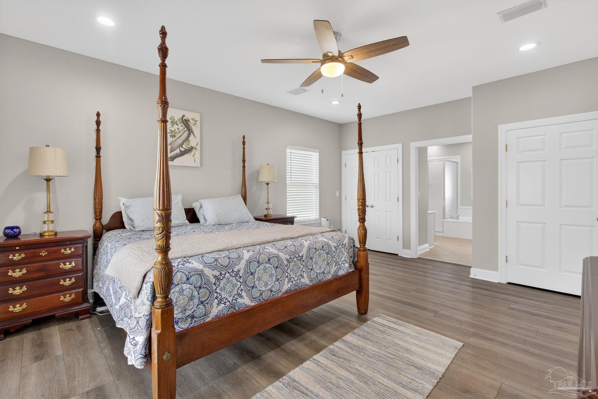 26355 Marina Road Orange Beach, AL 36561 - Photo 19 of 58 a bedroom with a bed chandelier and a window