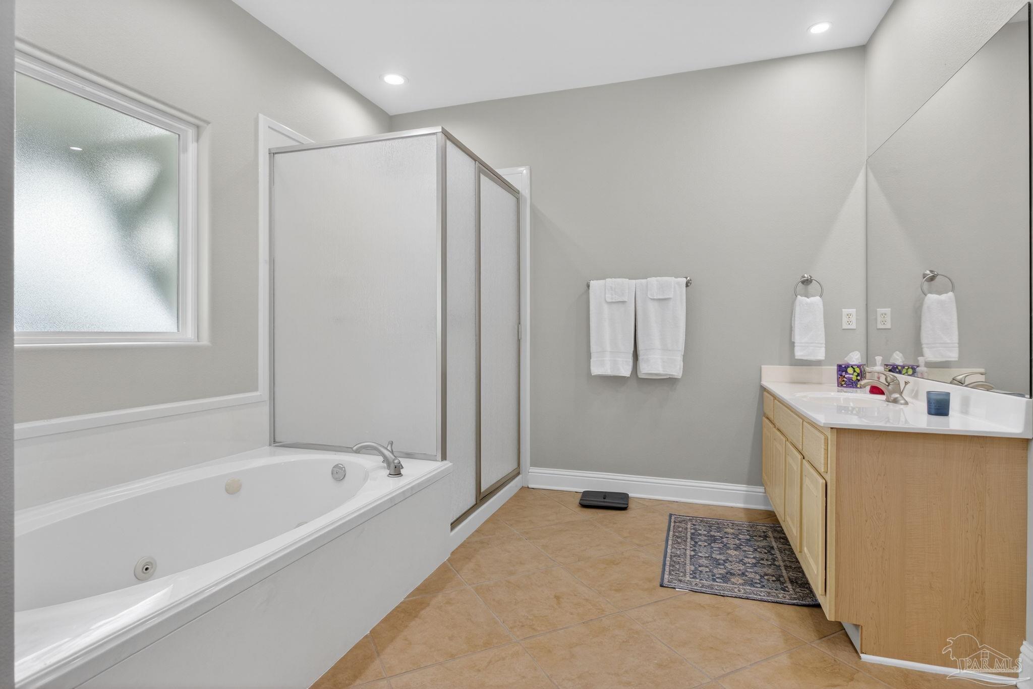 26355 Marina Road Orange Beach, AL 36561 - Photo 20 of 58 a bathroom with a bathtub and a shower