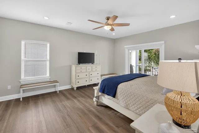 a bedroom with a large bed and a chandelier