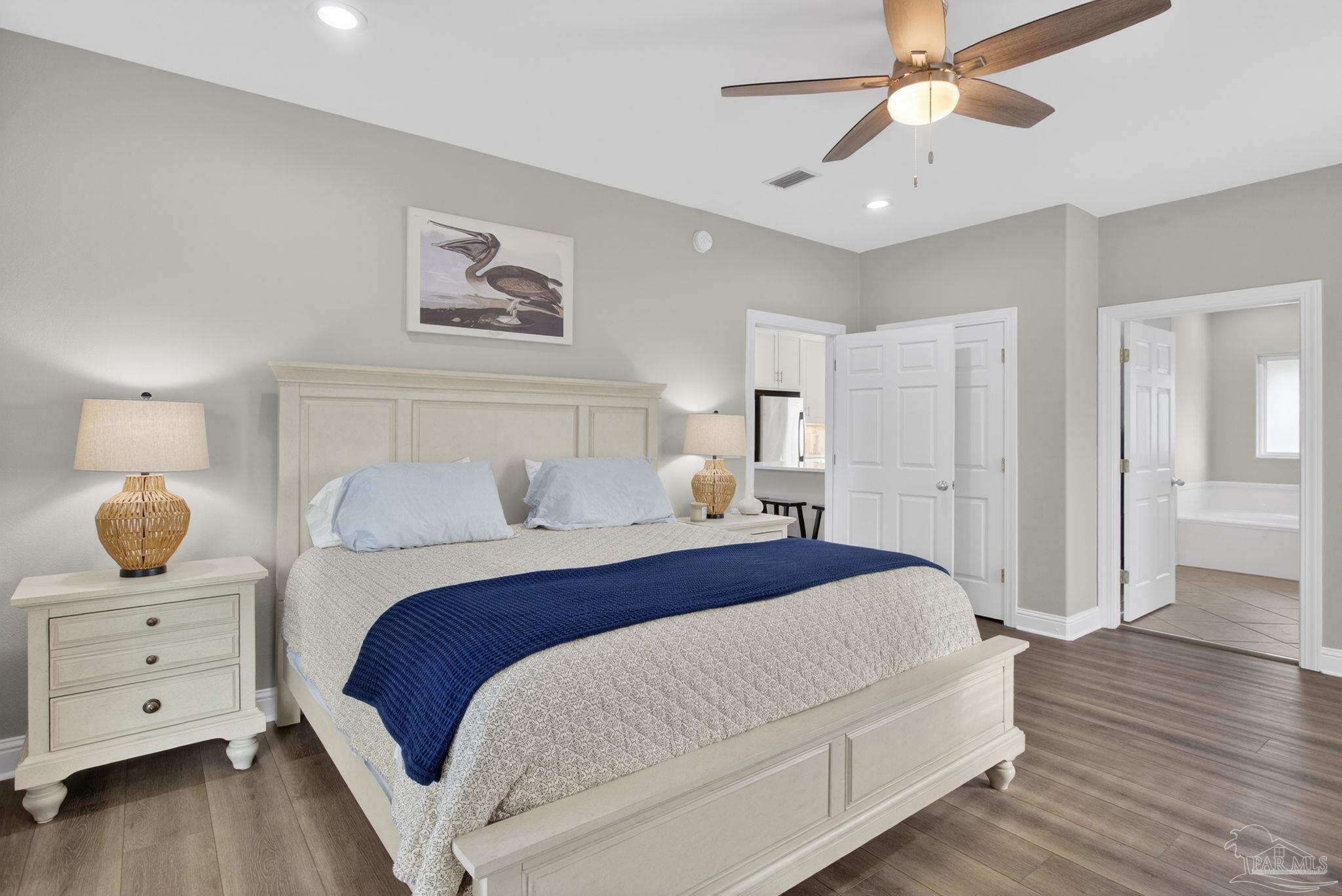 26355 Marina Road Orange Beach, AL 36561 - Photo 24 of 58 a bedroom with a large bed and a chandelier