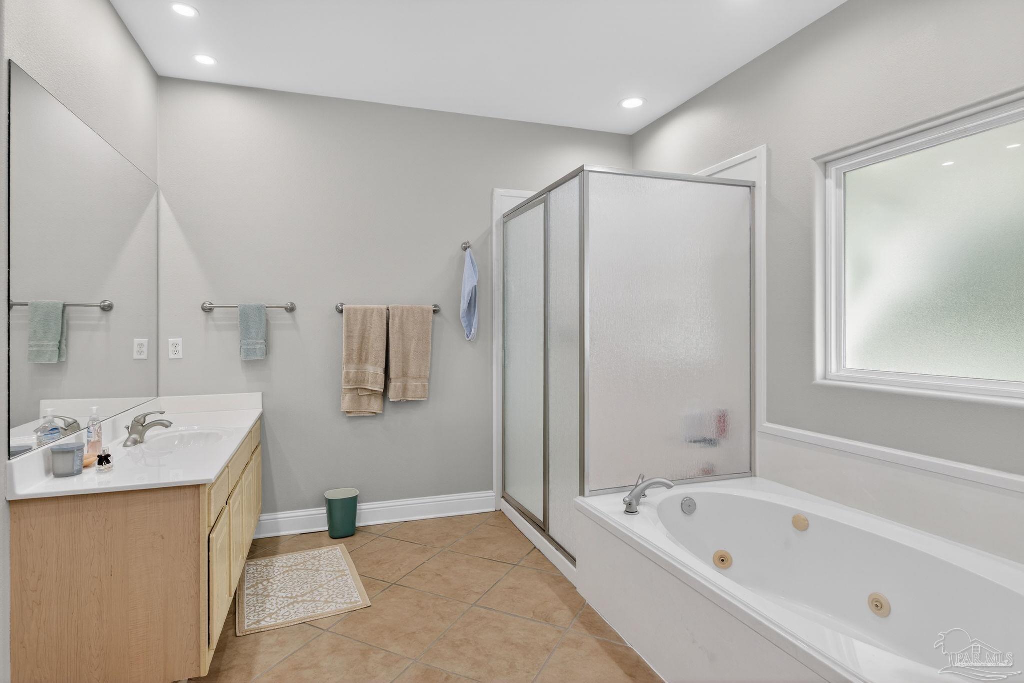 26355 Marina Road Orange Beach, AL 36561 - Photo 25 of 58 a bathroom with a tub a sink and a large mirror