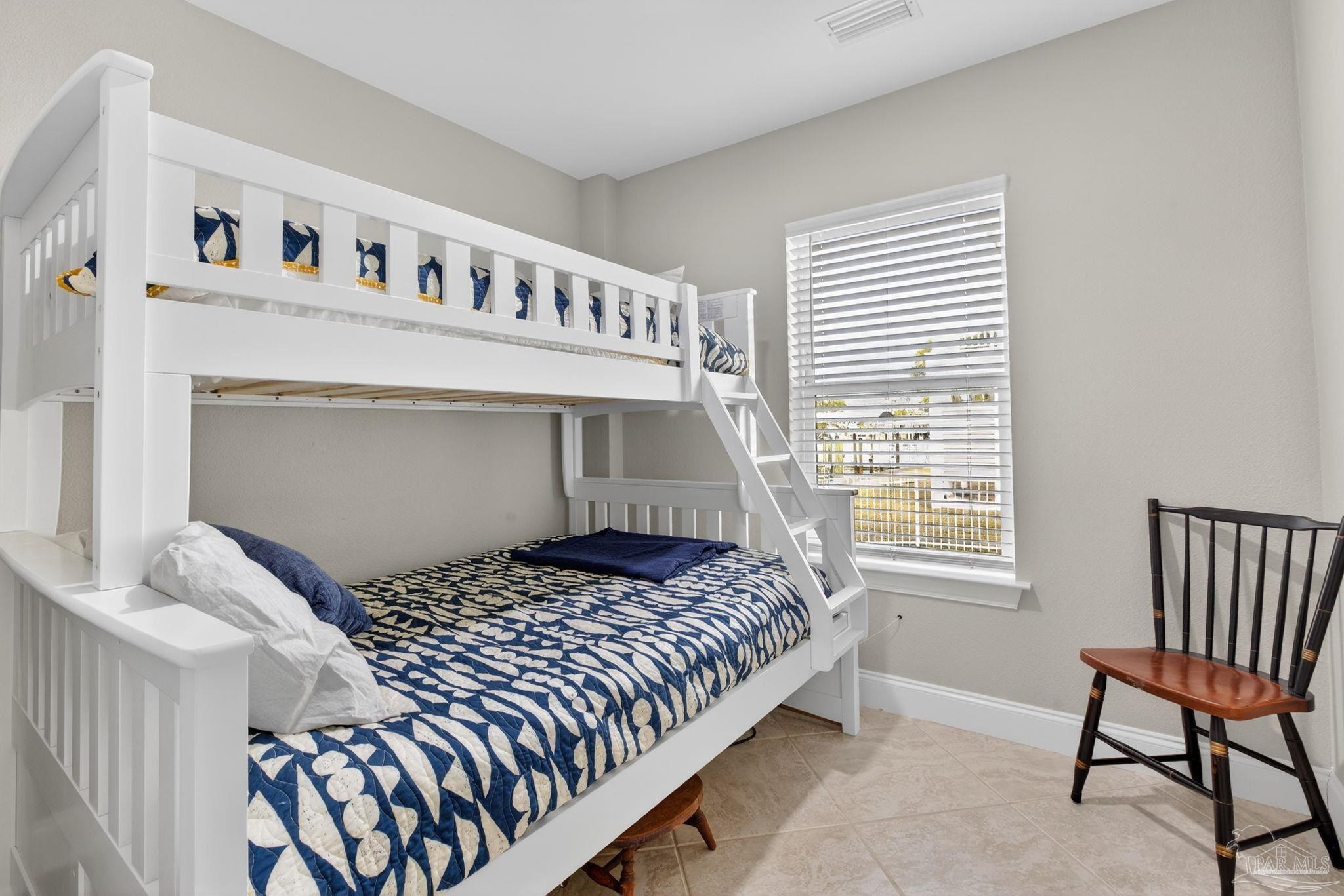 26355 Marina Road Orange Beach, AL 36561 - Photo 31 of 58 a bedroom with a bed and a chair