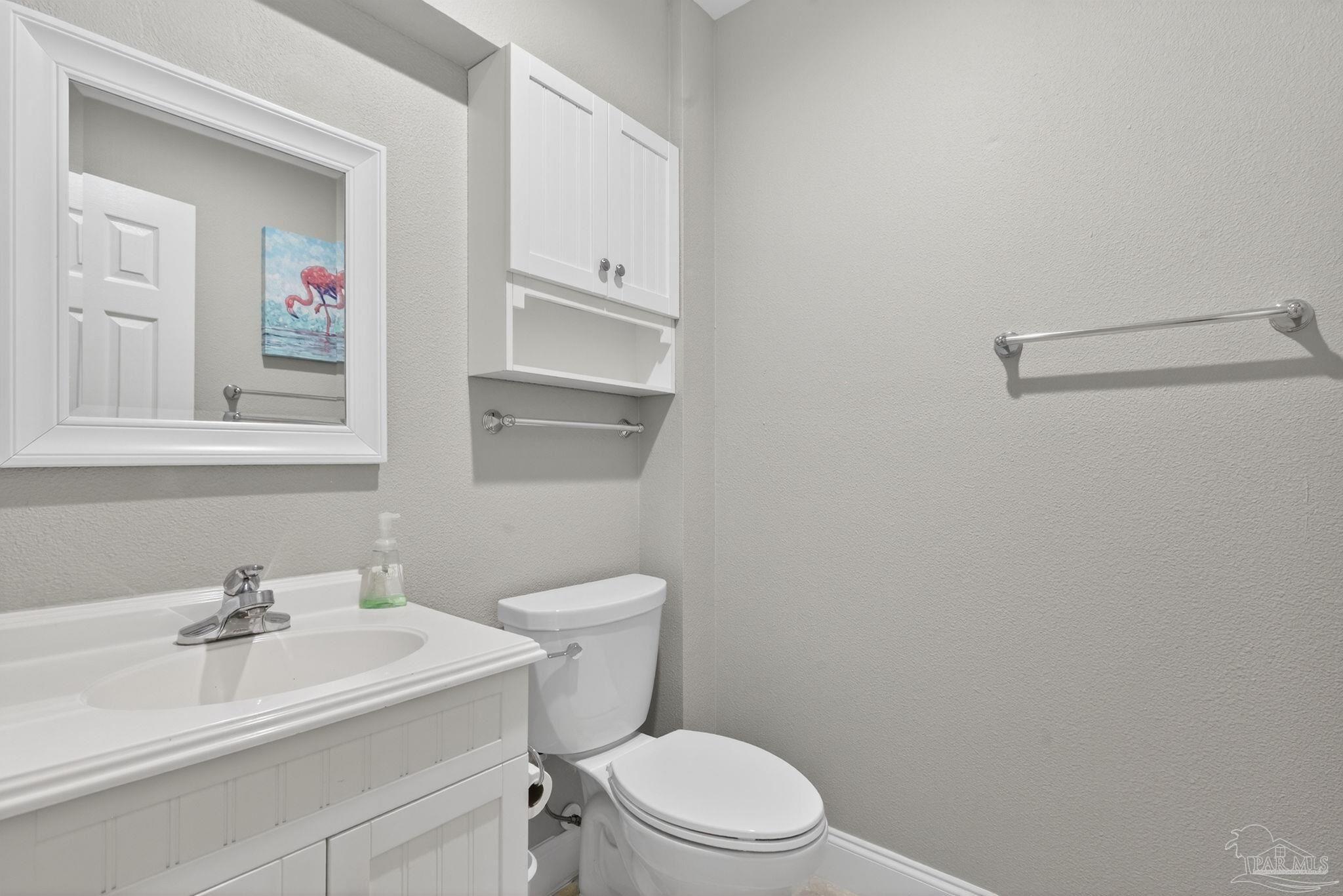 26355 Marina Road Orange Beach, AL 36561 - Photo 32 of 58 a bathroom with a sink a toilet and mirror