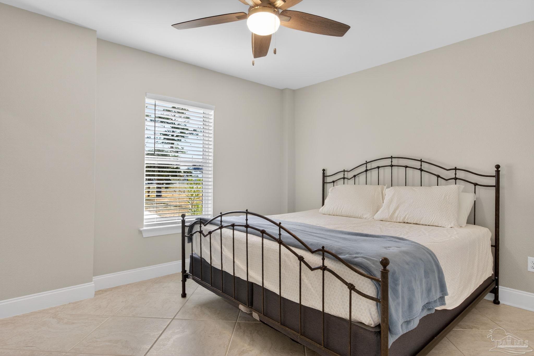 26355 Marina Road Orange Beach, AL 36561 - Photo 33 of 58 a bedroom with a bed and window