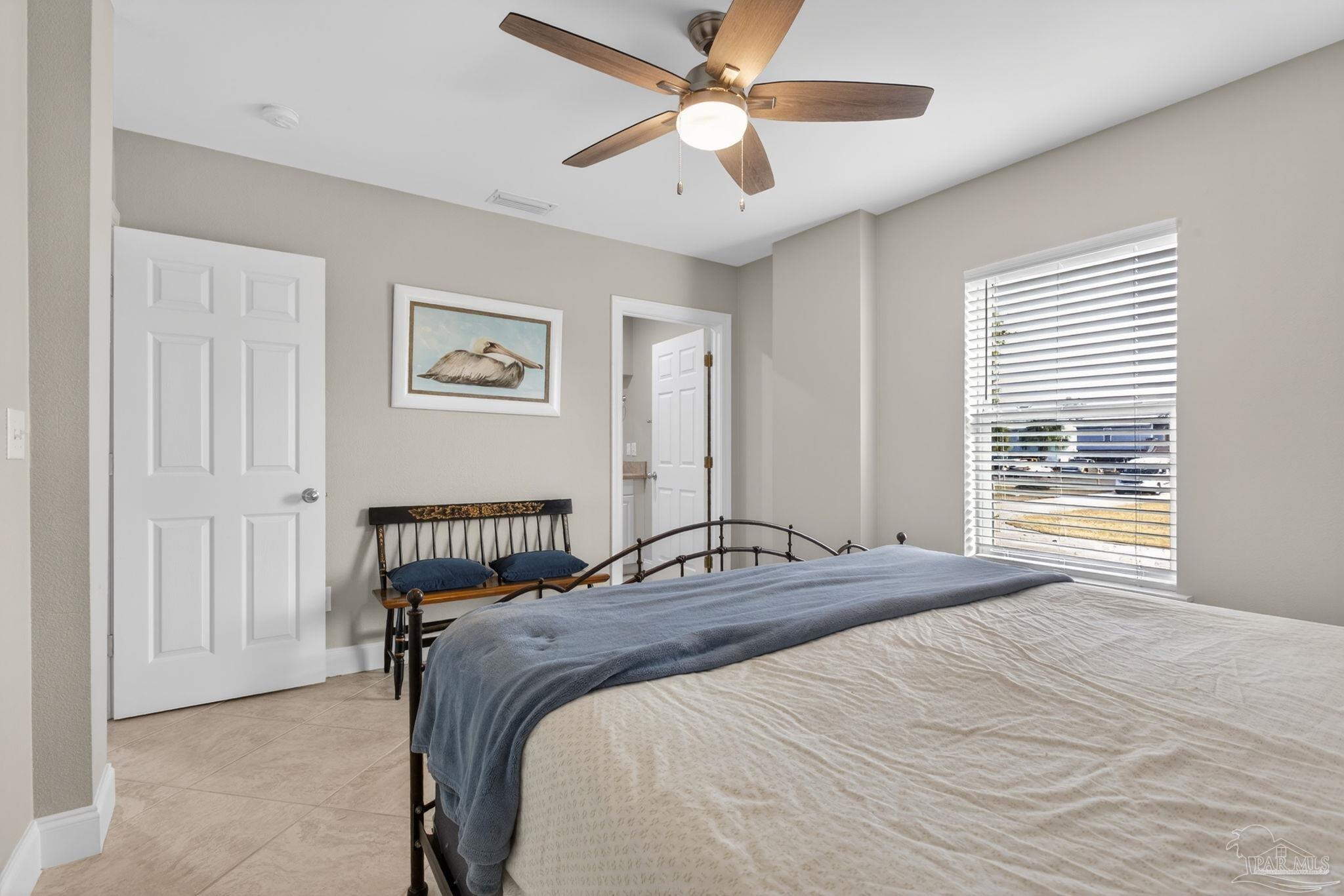 26355 Marina Road Orange Beach, AL 36561 - Photo 34 of 58 a bedroom with a bed and a large window