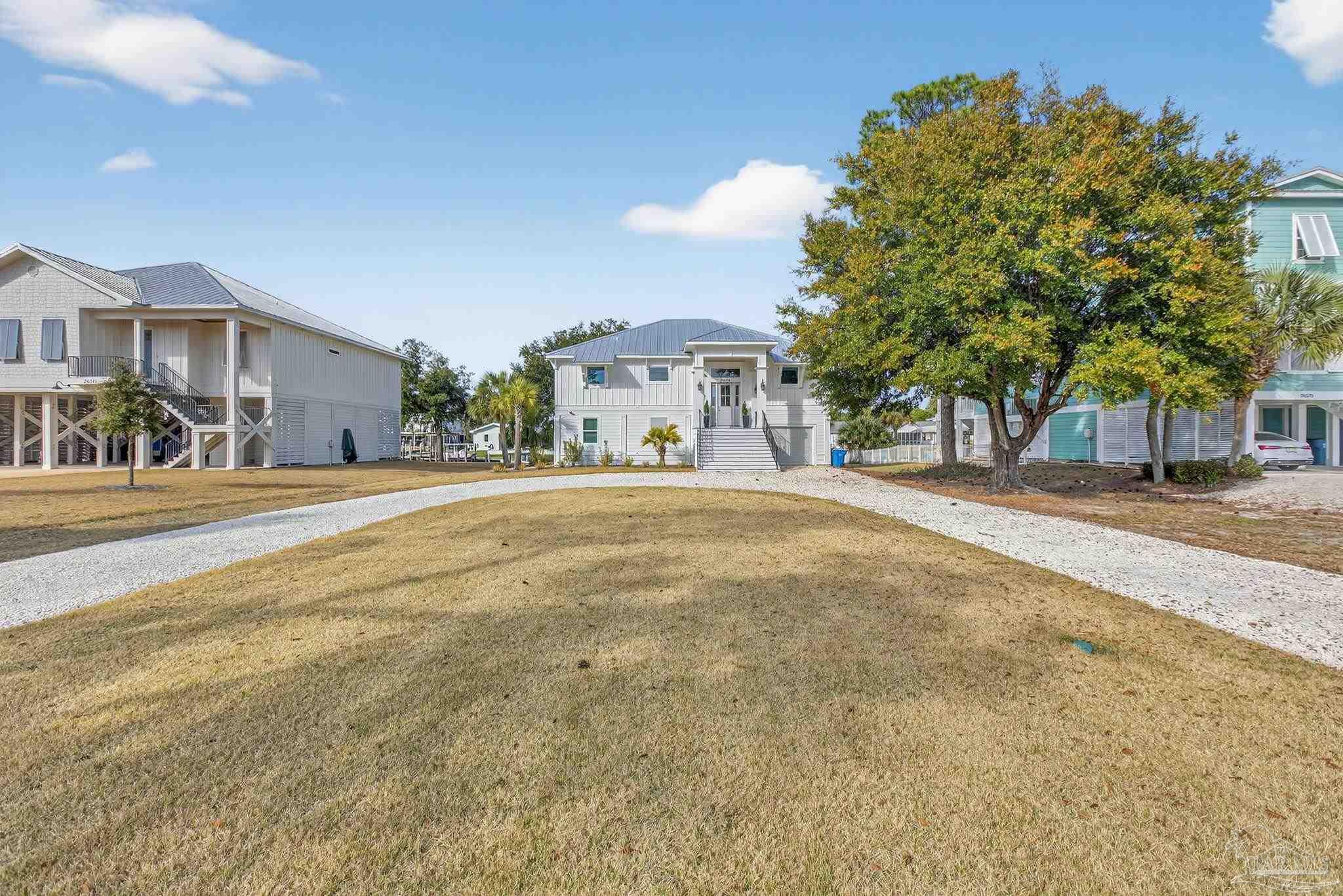 26355 Marina Road Orange Beach, AL 36561 - Photo 40 of 58 a front view of a building with trees
