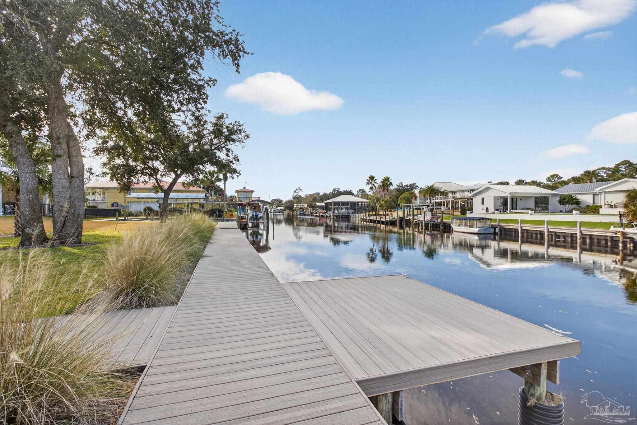 26355 Marina Road Orange Beach, AL 36561 - Photo 43 of 58 a view of a swimming pool with a table and chairs