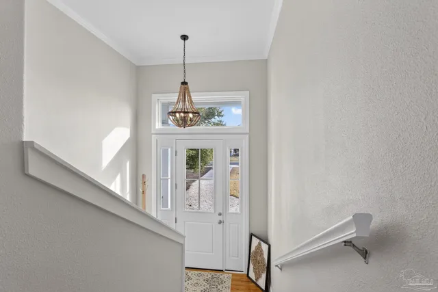 a living room with furniture and a dining table with wooden floor