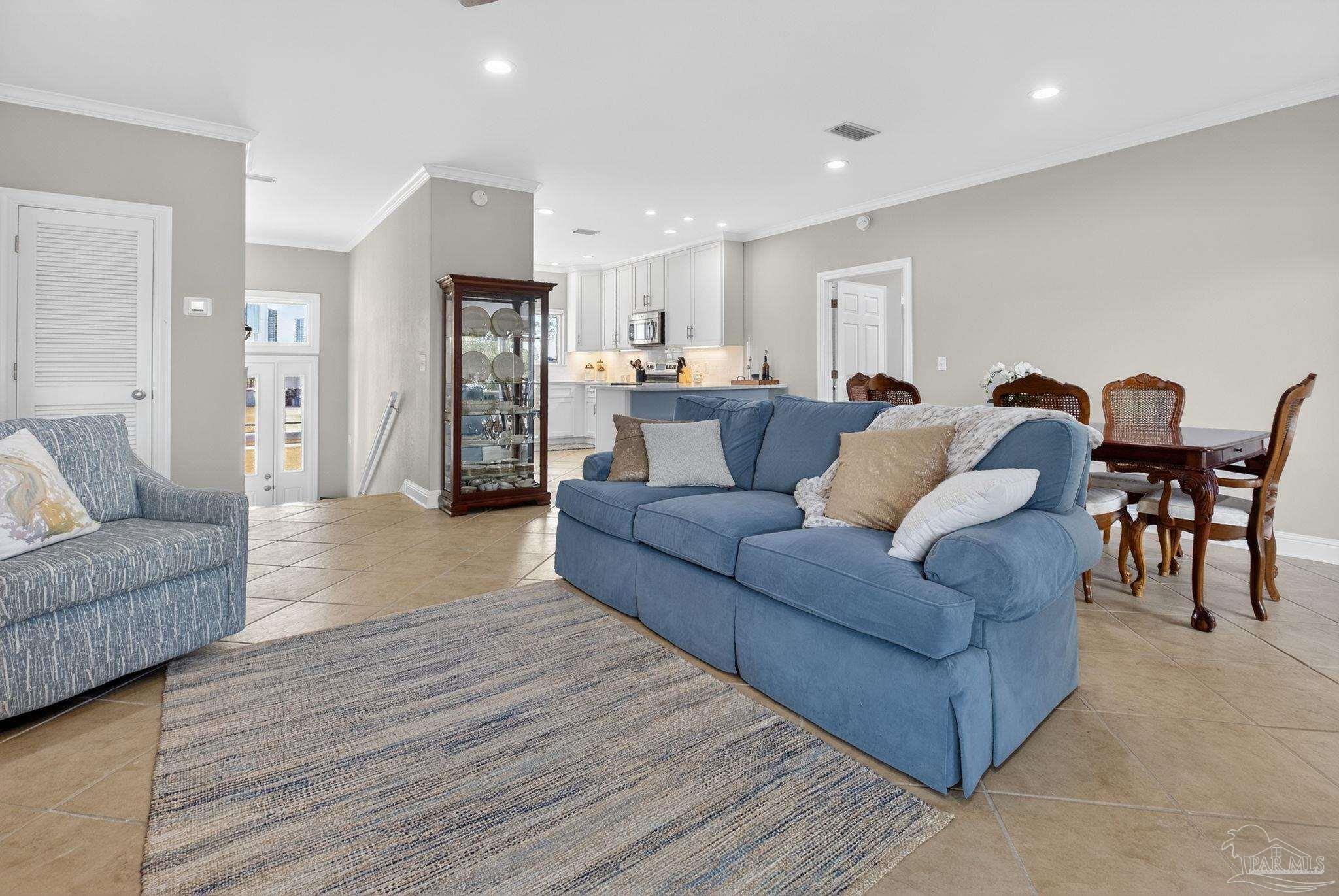 26355 Marina Road Orange Beach, AL 36561 - Photo 10 of 58 a living room with furniture and a dining table with wooden floor