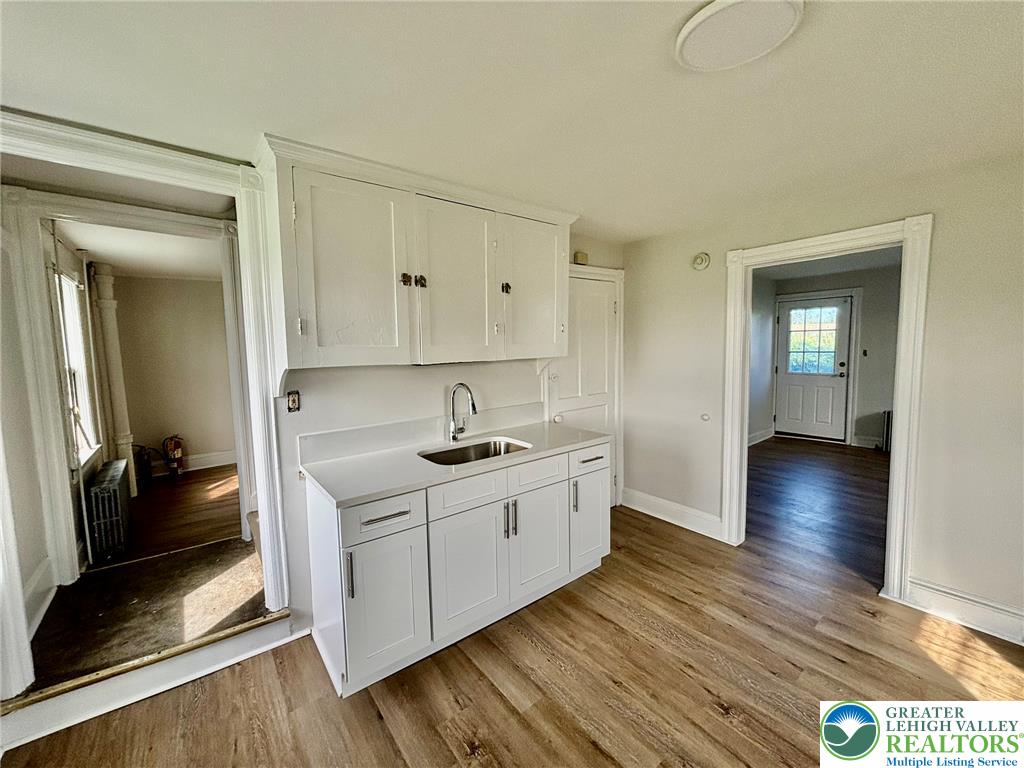 4067 Newburg Road Bethlehem, PA 18020 - Photo 11 of 19 Gleaming hardwood floors flow throughout this kitchen area with white cabinetry.