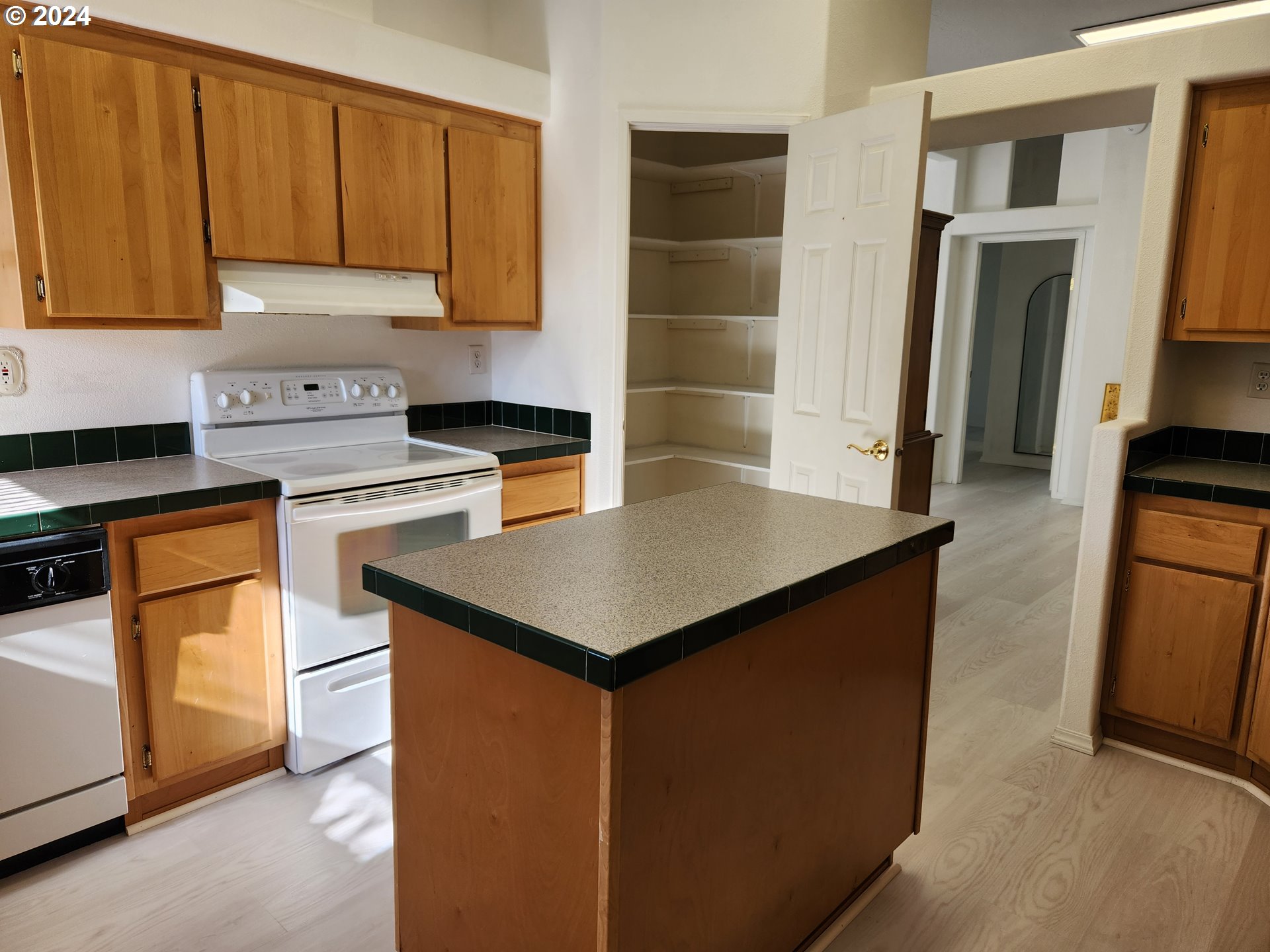 1675 Kristi Loop Lakeside, OR 97449 - Photo 13 of 30 a kitchen with stainless steel appliances a stove refrigerator sink and cabinets