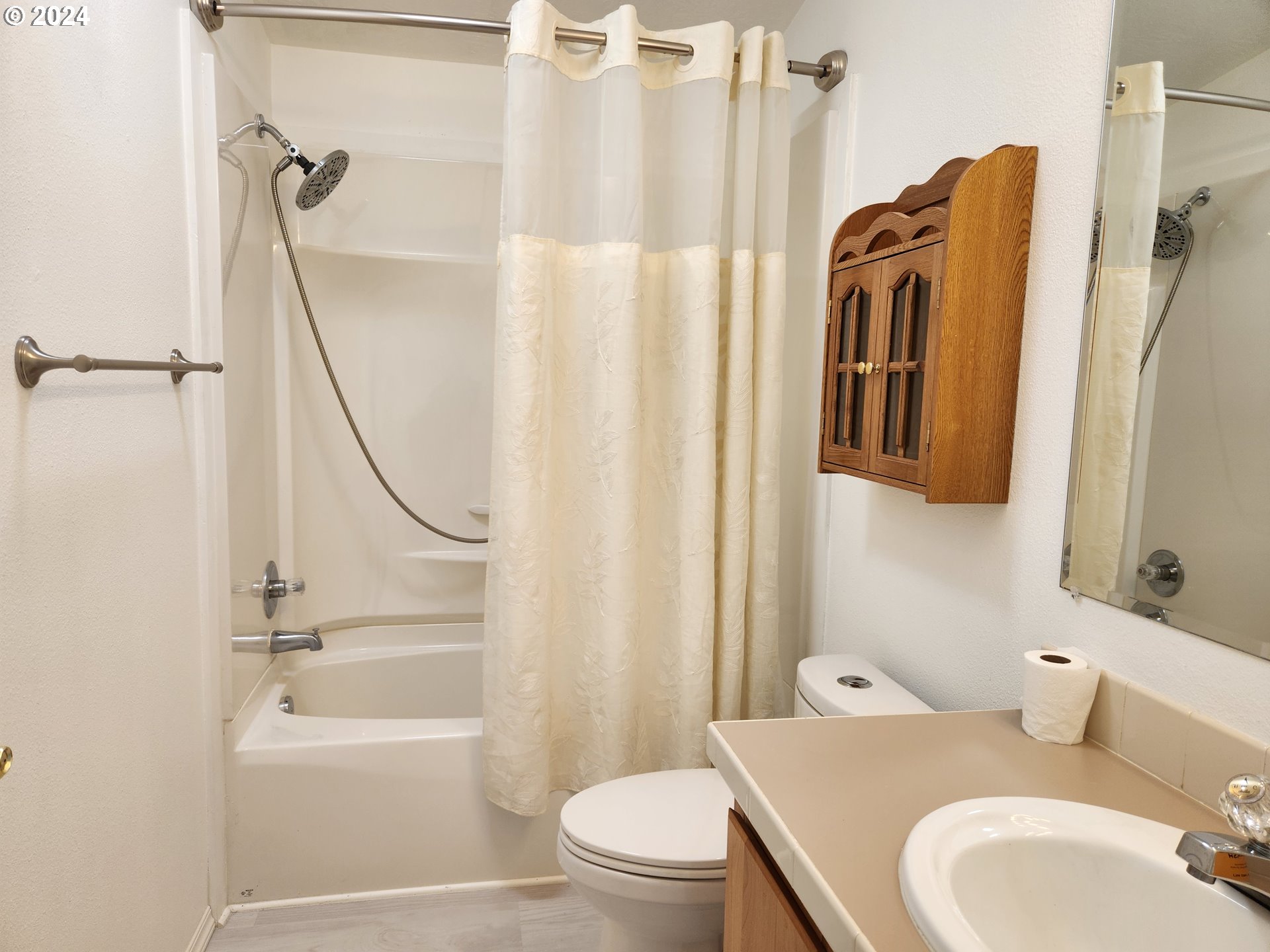 1675 Kristi Loop Lakeside, OR 97449 - Photo 24 of 30 a bathroom with a sink a toilet and a shower