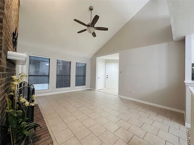 a view of a livingroom with a flesh screen tv and window