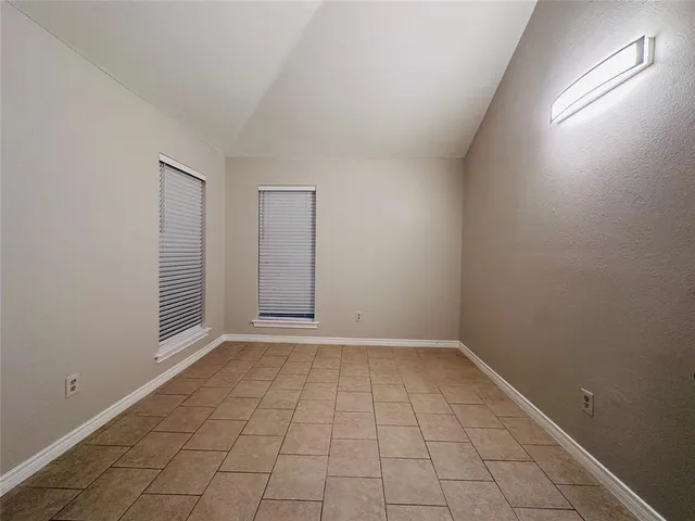 an empty room with white walls and tiles