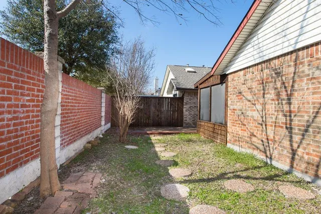 a backyard of a house with yard and outdoor seating