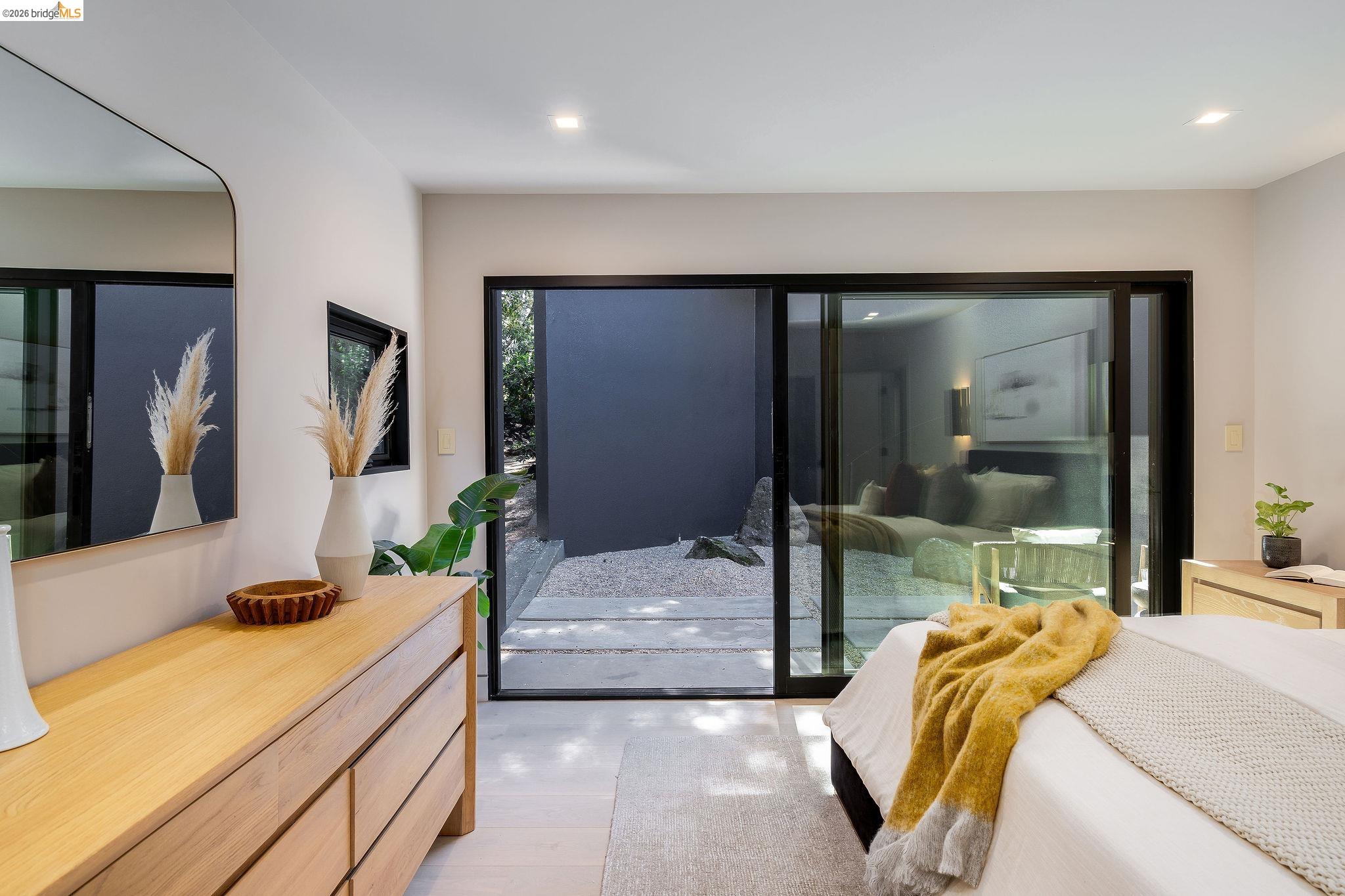 5645 Bacon Road Oakland, CA 94619 - Photo 46 of 94 Bedroom featuring light wood-finish flooring, recessed lighting, and a large sliding glass door opening to an outdoor patio area with gravel and plantings