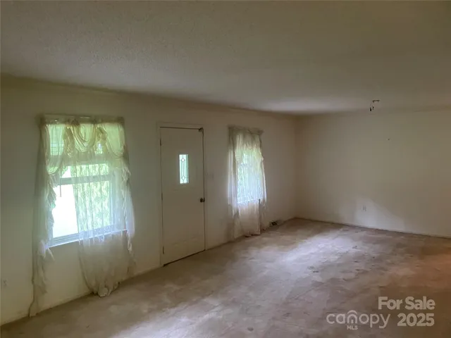 an empty room with closet and a ceiling fan