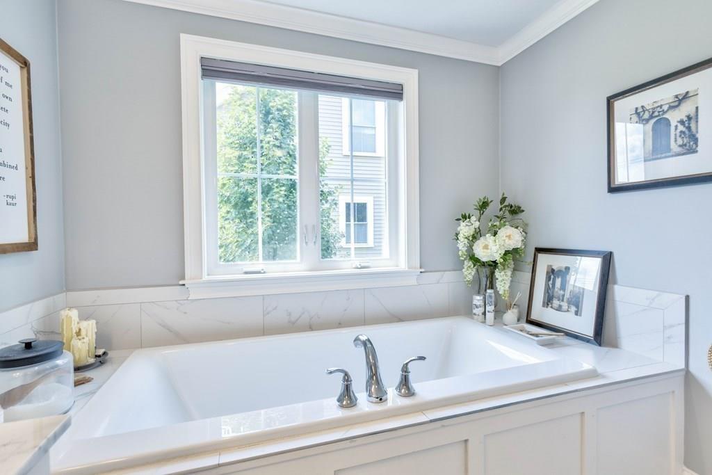 185 Cross Street Winchester, MA 01890 - Photo 18 of 41 a bathroom with a tub sink and mirror