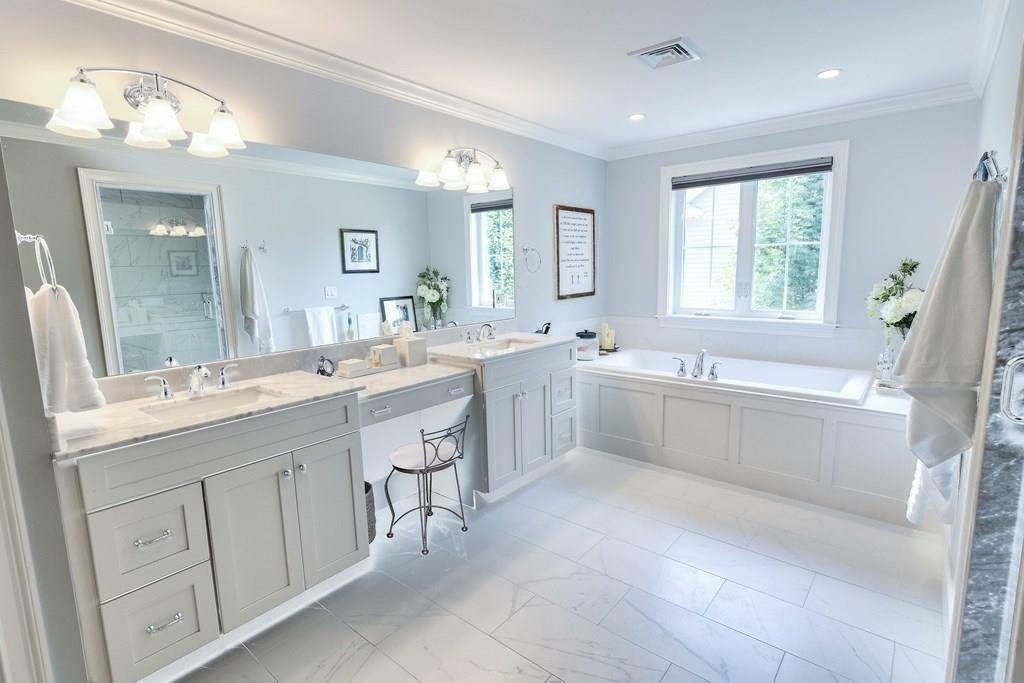 185 Cross Street Winchester, MA 01890 - Photo 19 of 41 a large white bathroom with a large tub sink vanity granite and a mirror