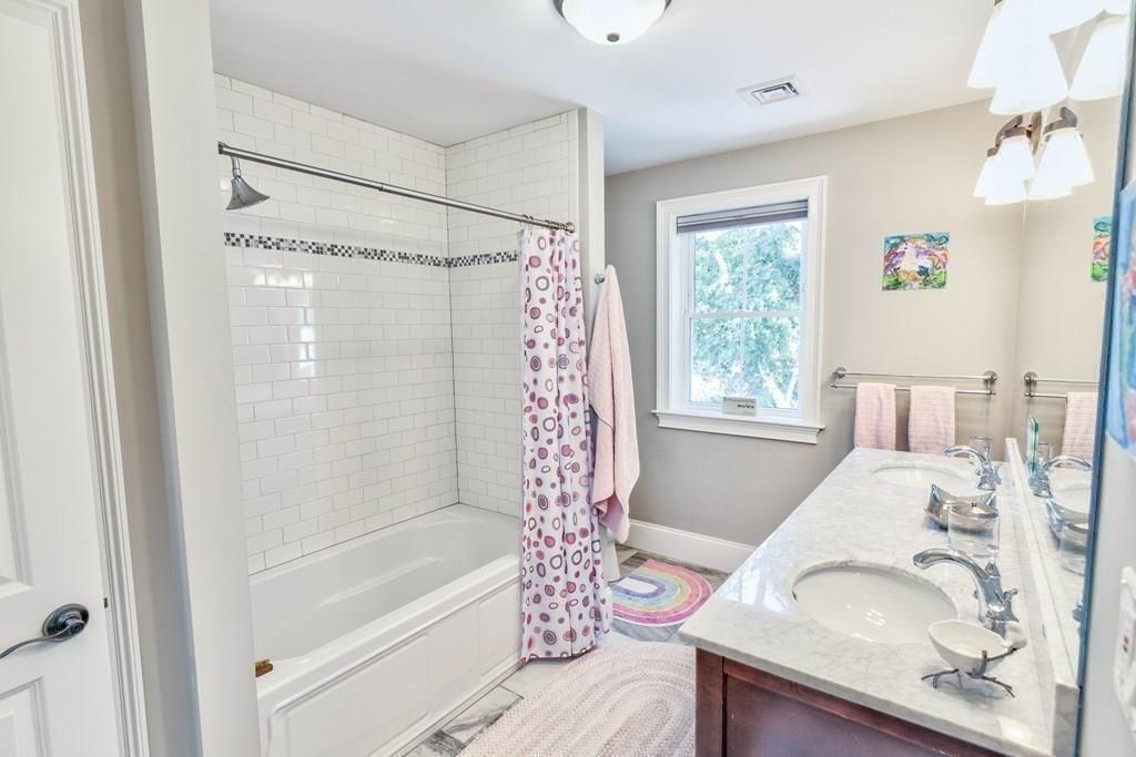185 Cross Street Winchester, MA 01890 - Photo 22 of 41 a bathroom with a bathtub and a sink
