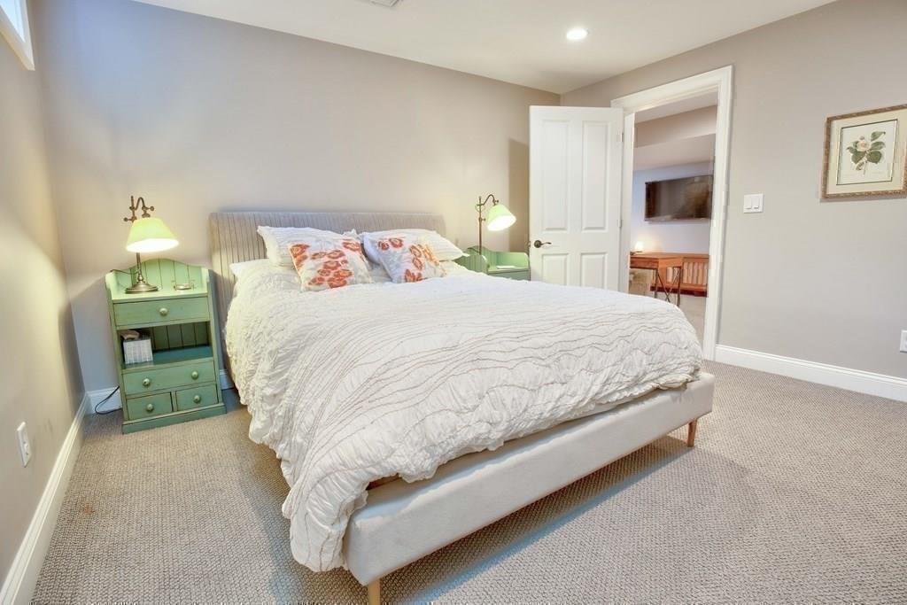 185 Cross Street Winchester, MA 01890 - Photo 37 of 41 a bed sitting in a bedroom next to a lamp