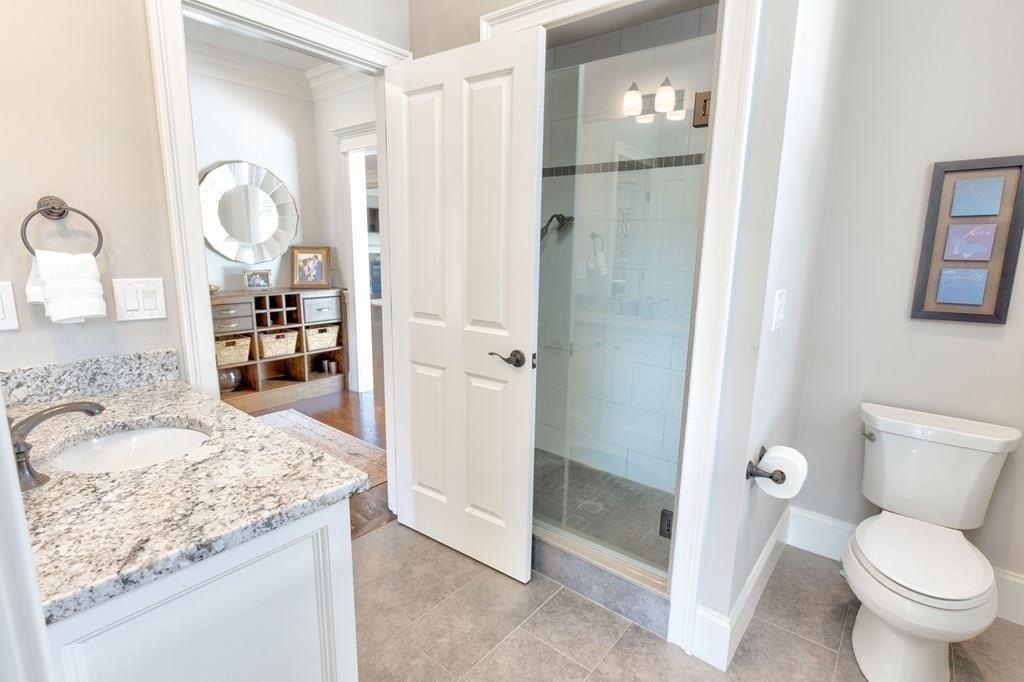 185 Cross Street Winchester, MA 01890 - Photo 6 of 41 a bathroom with a granite countertop sink toilet and shower