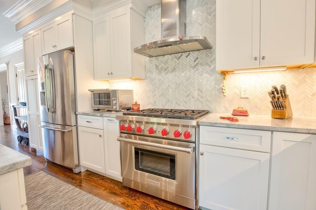 185 Cross Street Winchester, MA 01890 - Photo 10 of 41 a kitchen with stainless steel appliances a stove and a refrigerator