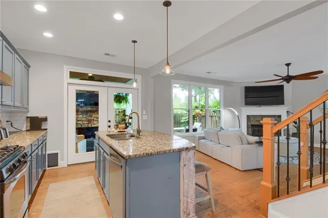 a kitchen with sink refrigerator and stove