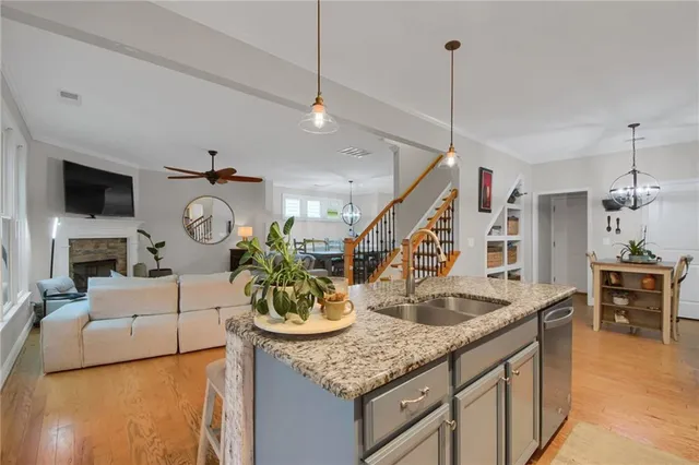 a living room with fireplace furniture and a wooden floor